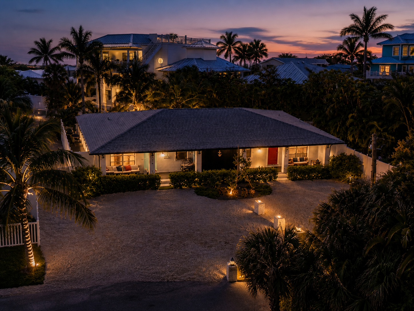The property at dusk with warm landscape lighting