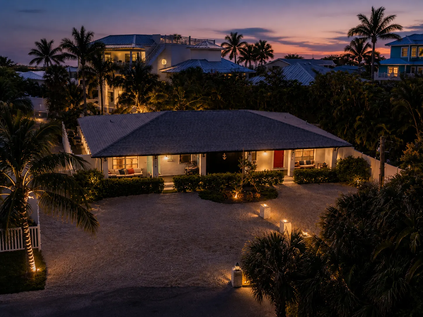 The property at dusk with warm landscape lighting